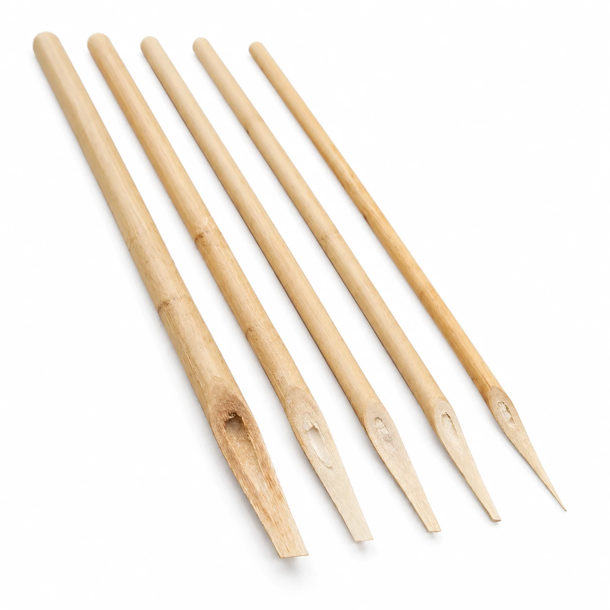 Fine khatati qalams seen along their length showing tapered bamboo barrels and narrow hand-cut chisel nibs