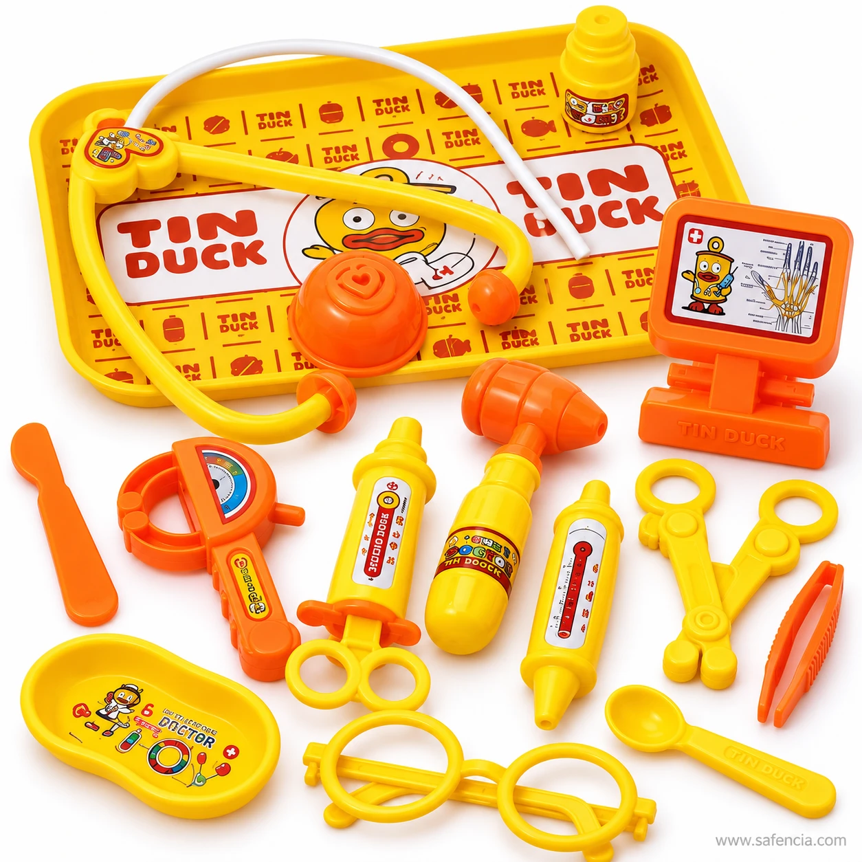 Toy stethoscope on the Tin Duck tray beside an x-ray screen on a stand, a toy syringe, thermometer, hammer and round glasses