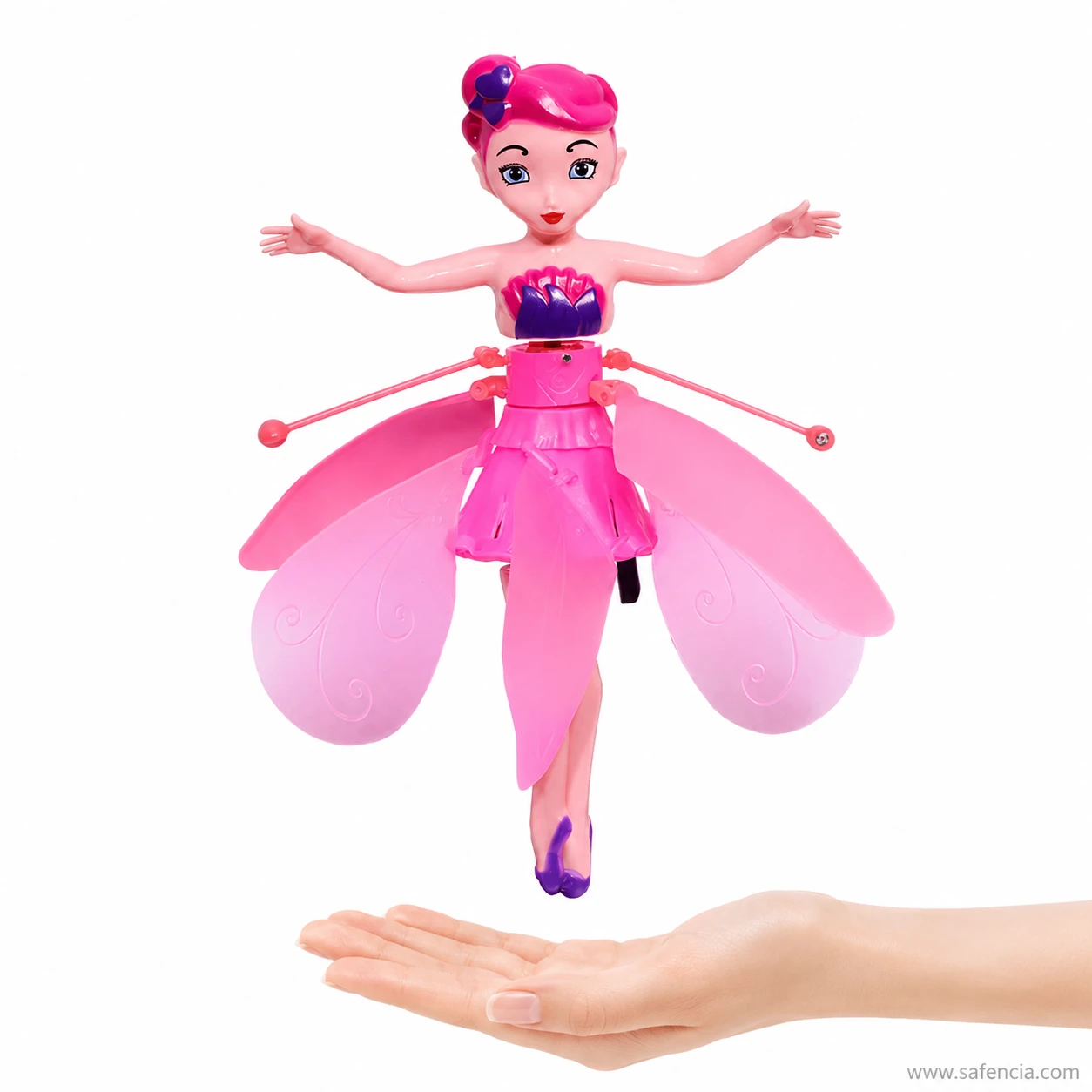 Flying fairy doll hovering in the air above an open palm held flat underneath her