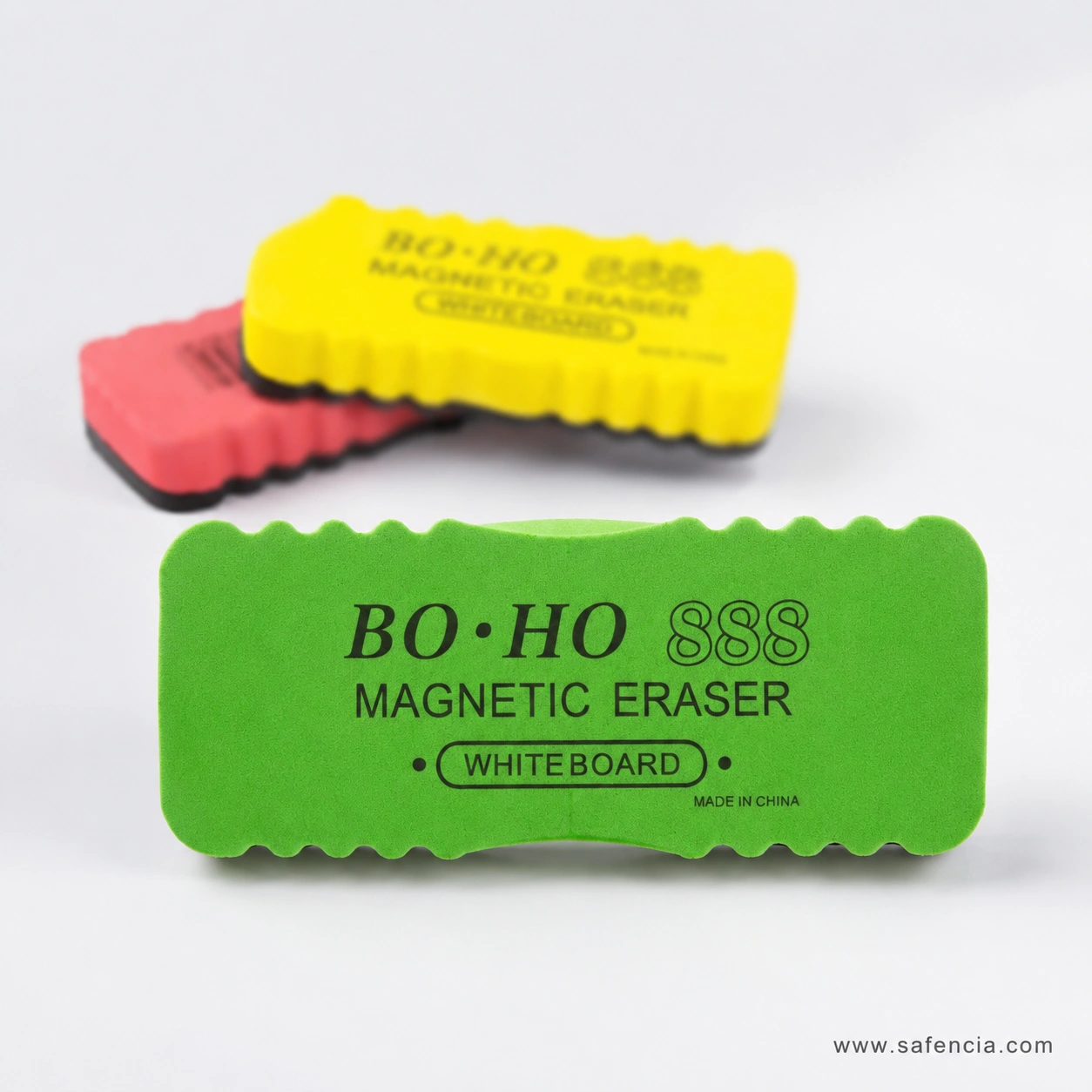 Angled view of the magnetic whiteboard erasers showing the foam thickness and dark wiping pad under each colour