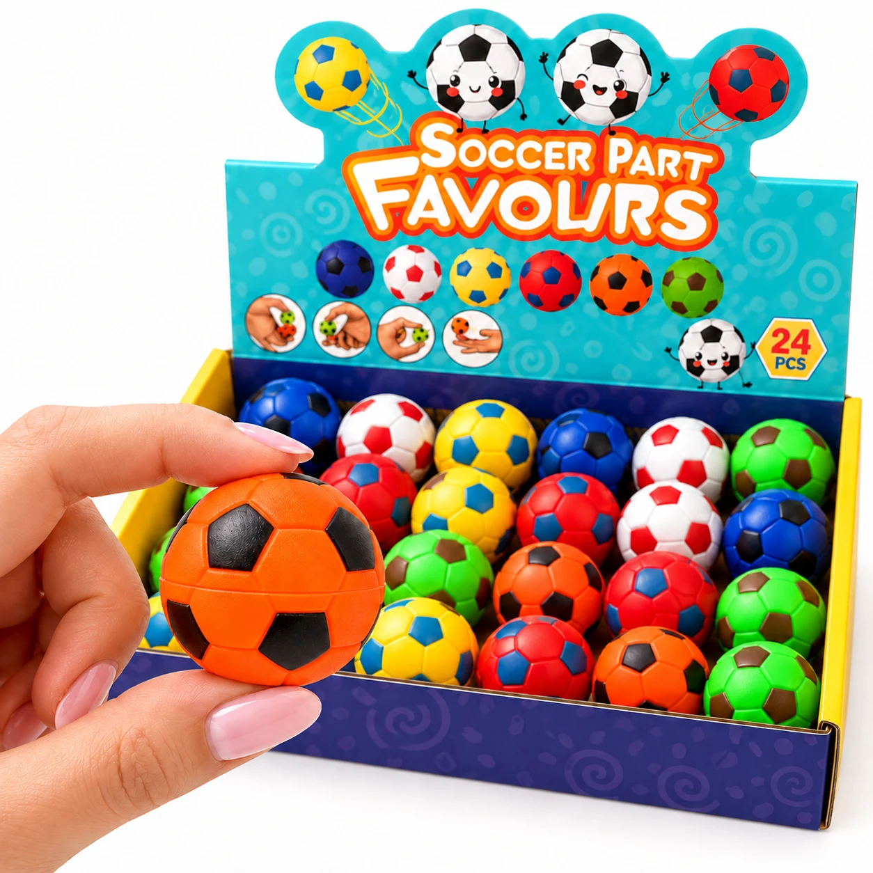 Fingers holding an orange and black mini football fidget ball in front of a box of mini footballs
