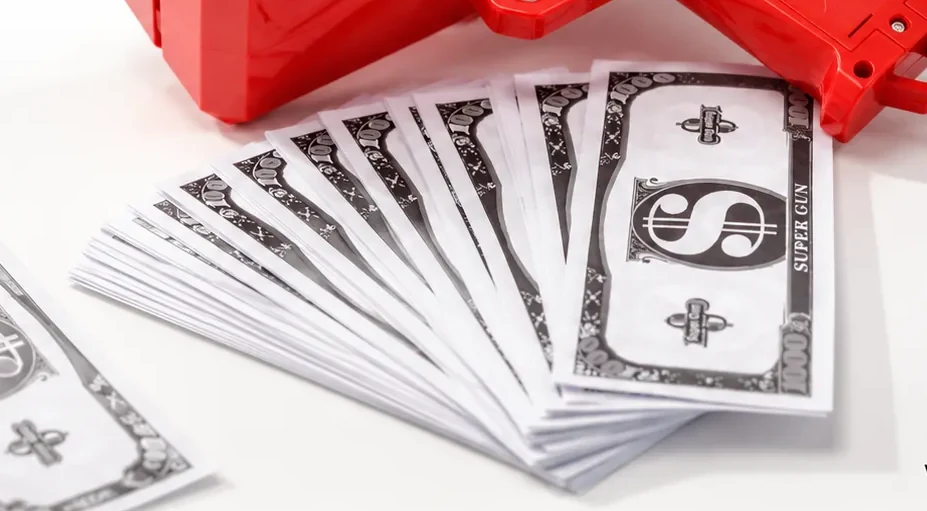 Close-up of the play money notes included with the super money gun party toy