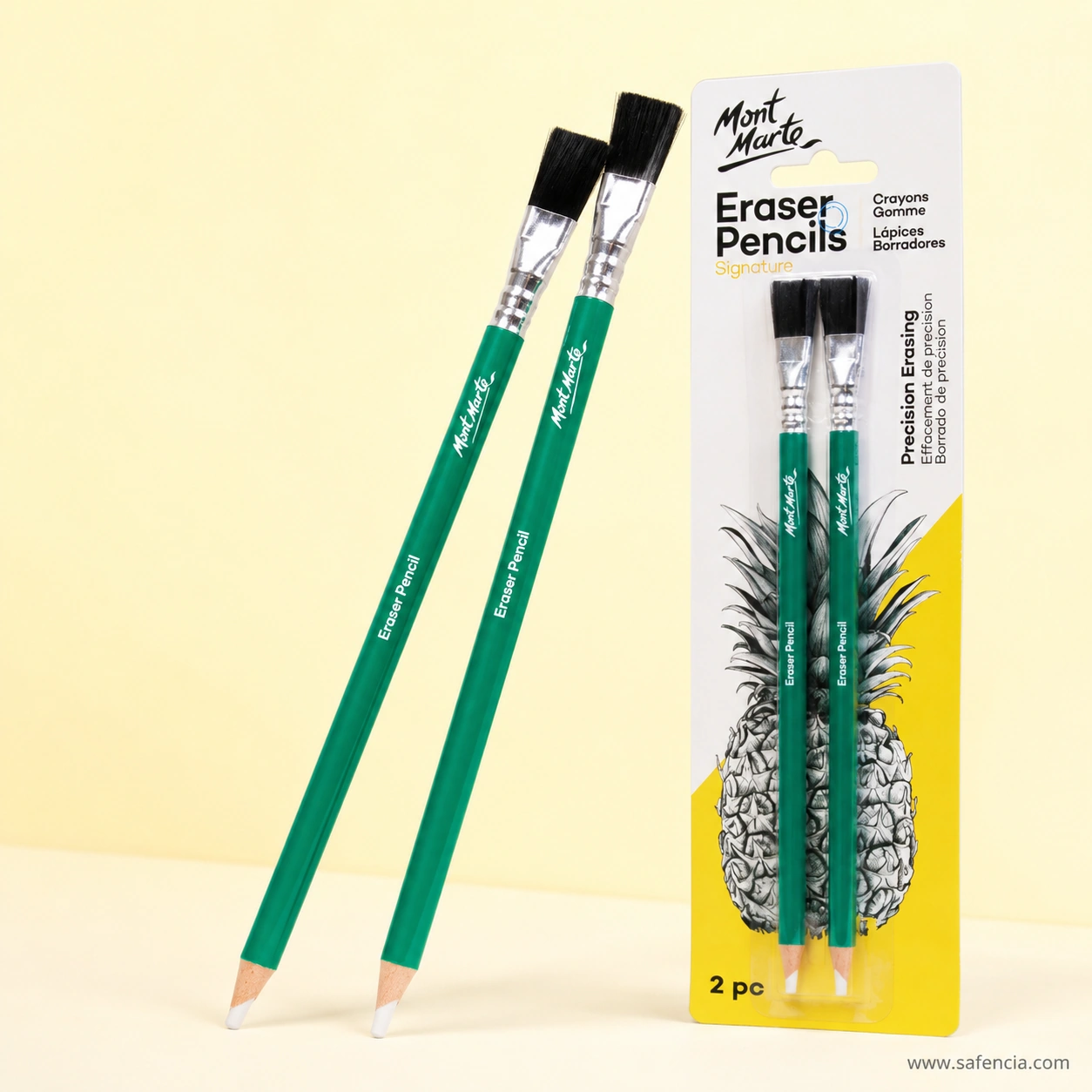 Two green Mont Marte eraser pencils standing beside the sealed pack, showing the white eraser core exposed at the sharpened tip and the flat black brush held in a crimped metal ferrule