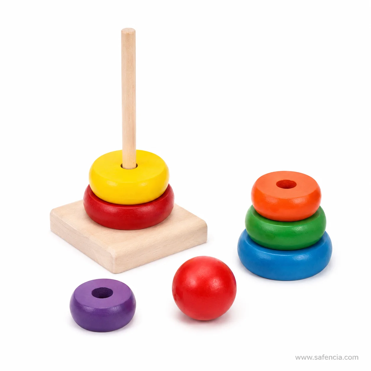 Rainbow tower partly stacked with two rings on the post and the rest loose beside it