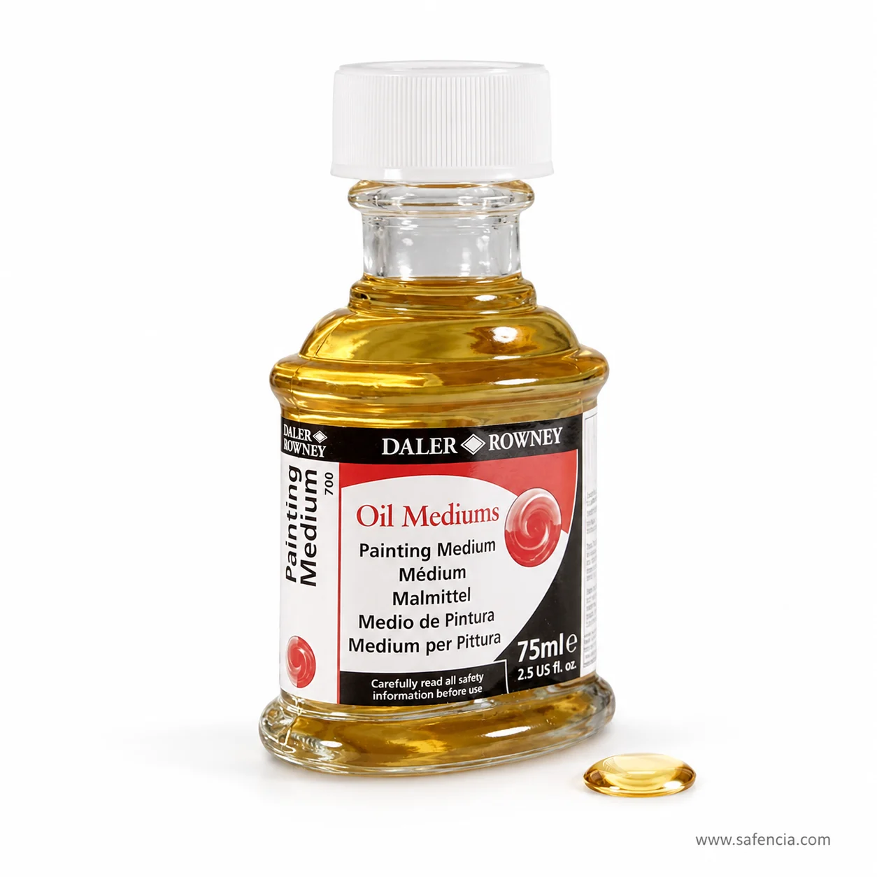 Oil painting medium bottle beside a single golden bead of the medium on a white surface