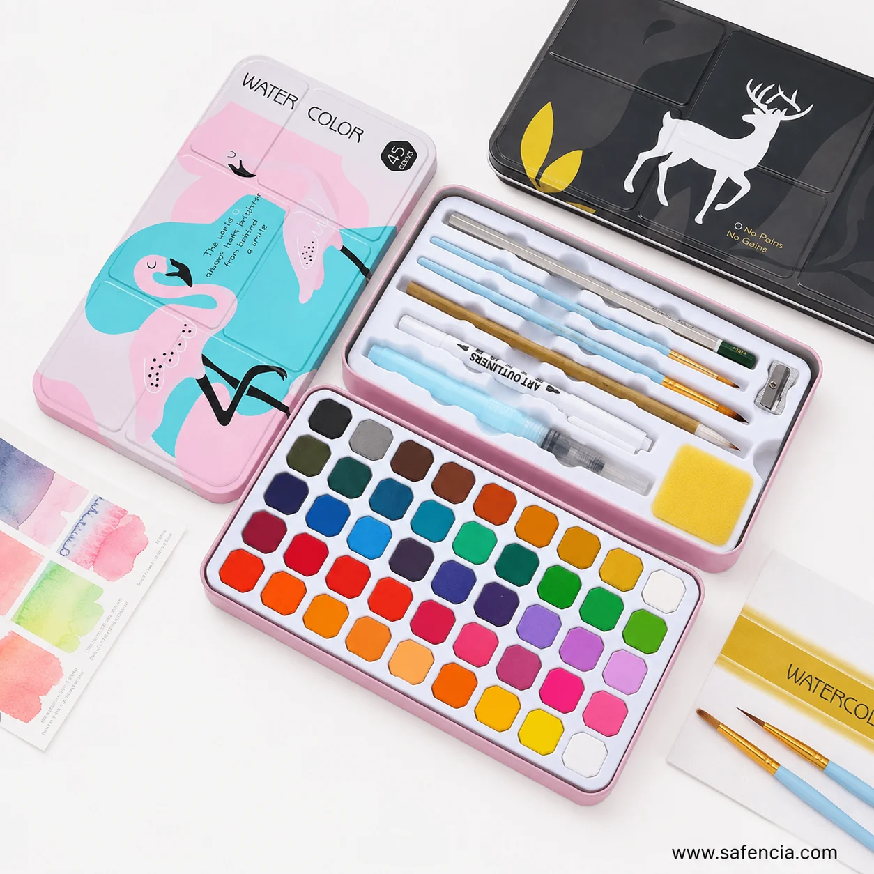 Flamingo watercolour tin beside painted swatches showing the greens and neutrals in the forty-five tray