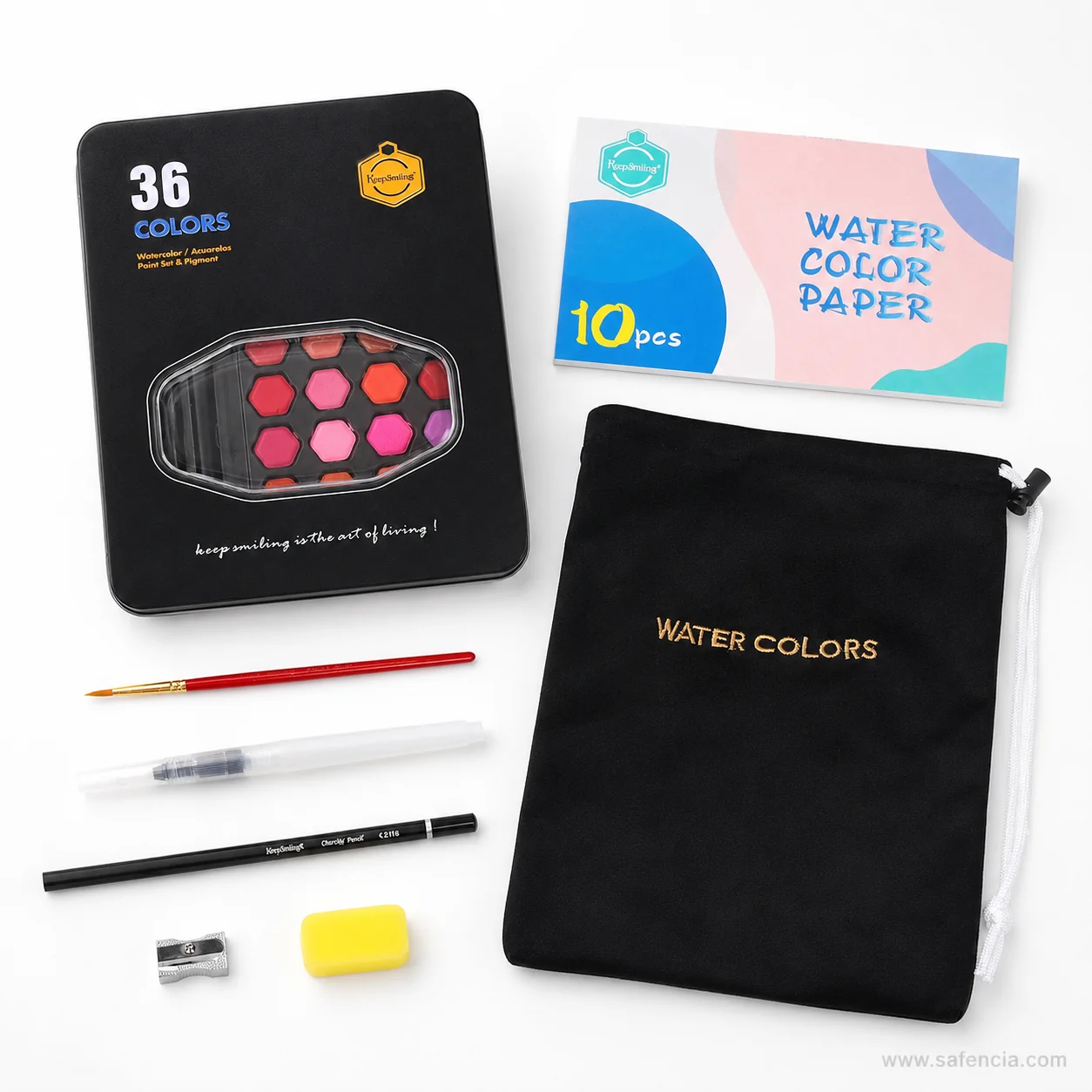 Flat lay of the Keep Smiling 36 kit with the tin, pouch, paper pad, two brushes, pencil and sharpener