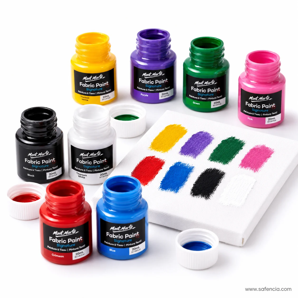 Open Mont Marte fabric paint bottles beside brushed swatches of yellow purple green pink and black