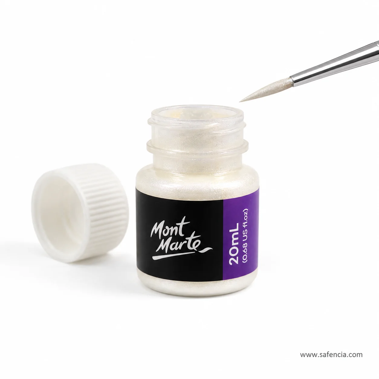 Open bottle of iridescent foil paint tipped on its side with a fine brush resting against the neck