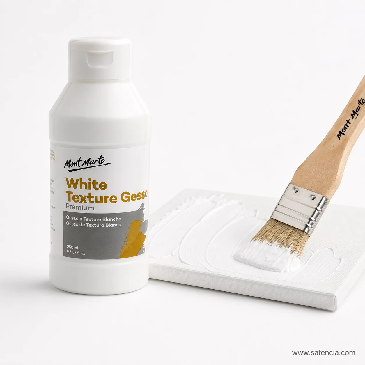 White texture gesso bottle beside a wide flat brush loaded with gesso over a primed board