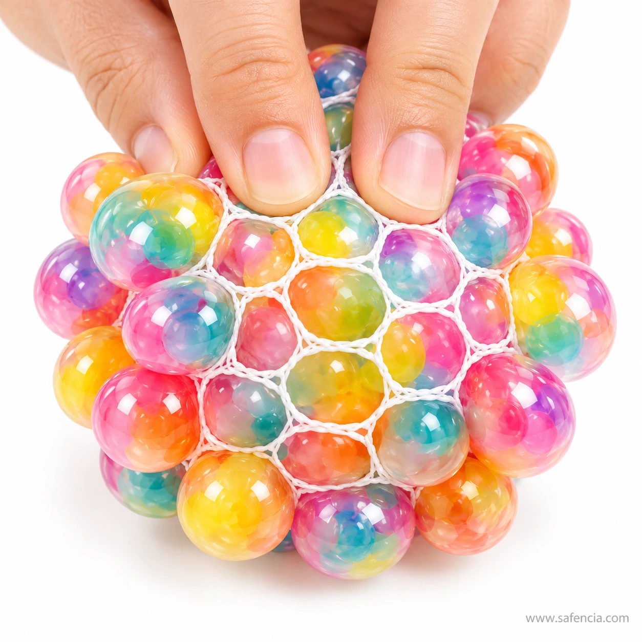Fingertips pressing into the top of the rainbow mesh stress ball as bubbles rise around them