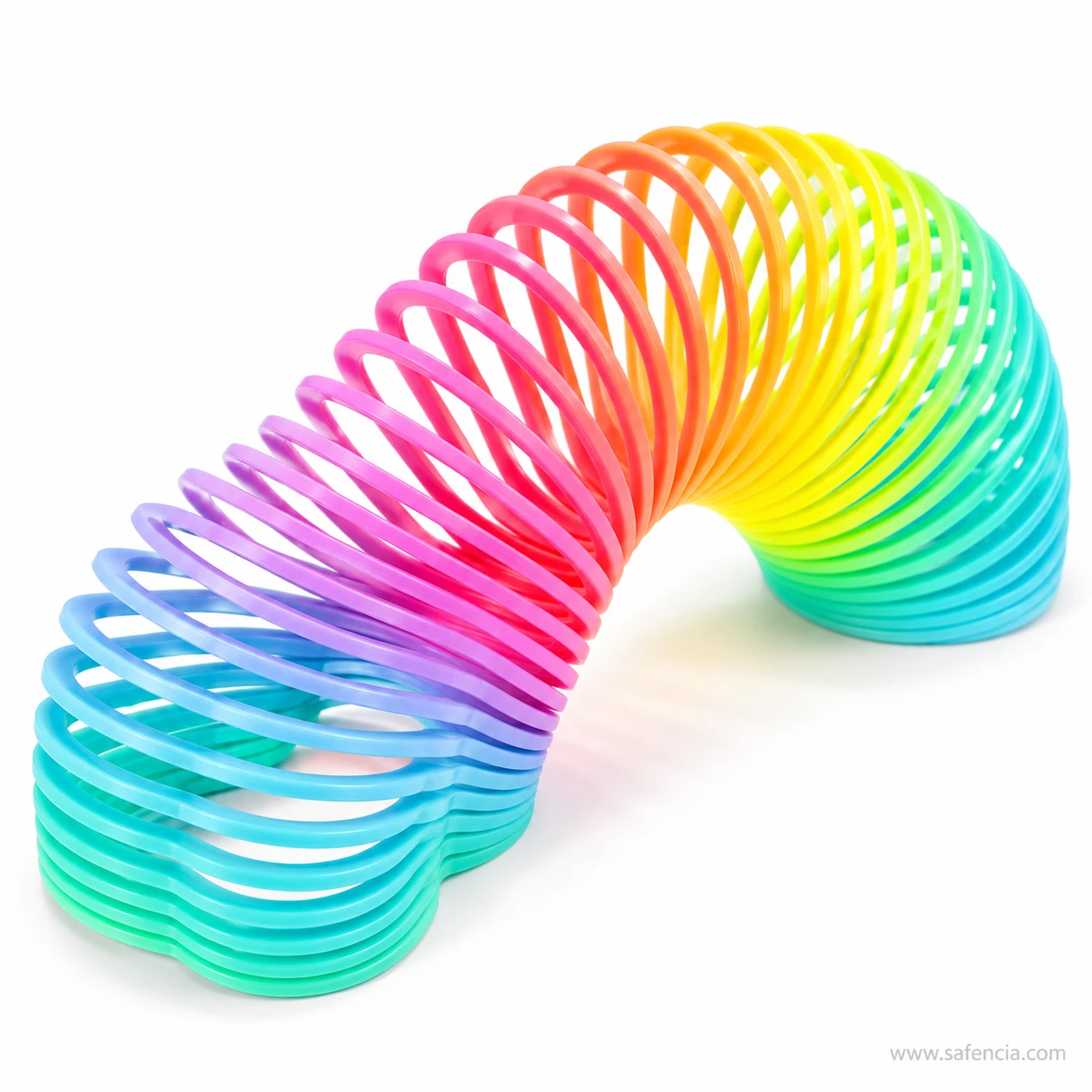 Rainbow slinky spring toy stretched into a wave with pink, yellow and blue rings