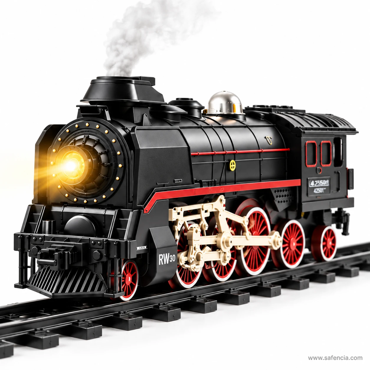 Green and black RC steam locomotive running on track with smoke rising from its chimney and the headlamp lit