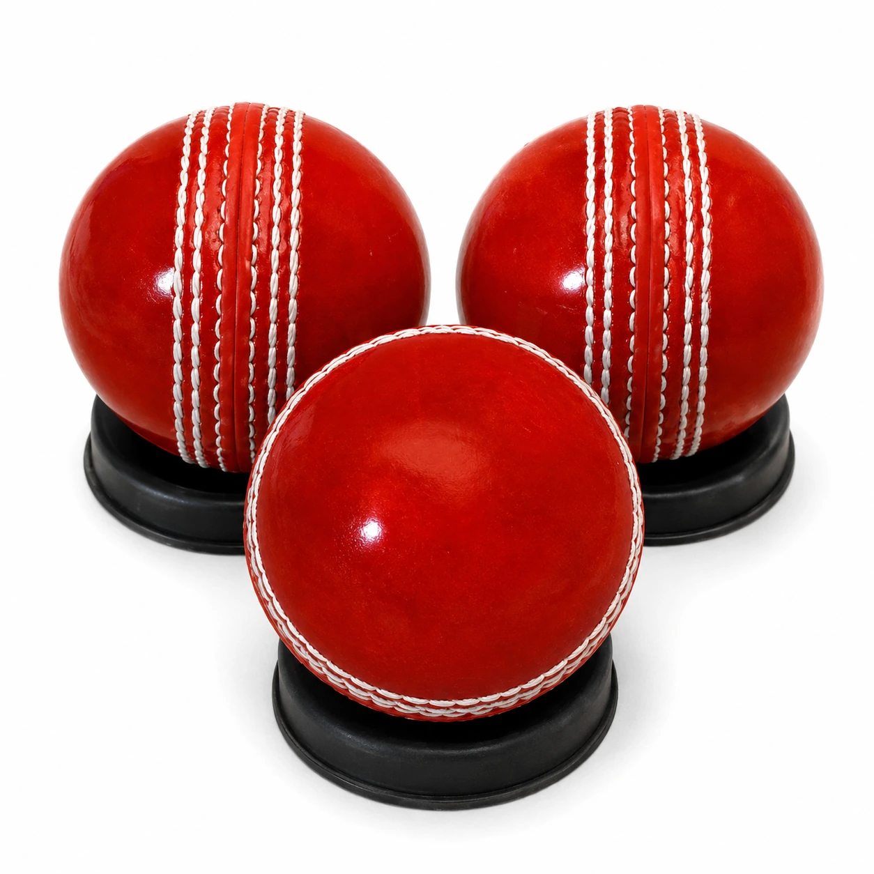 Master red practice cricket ball close up showing raised white stitched seam