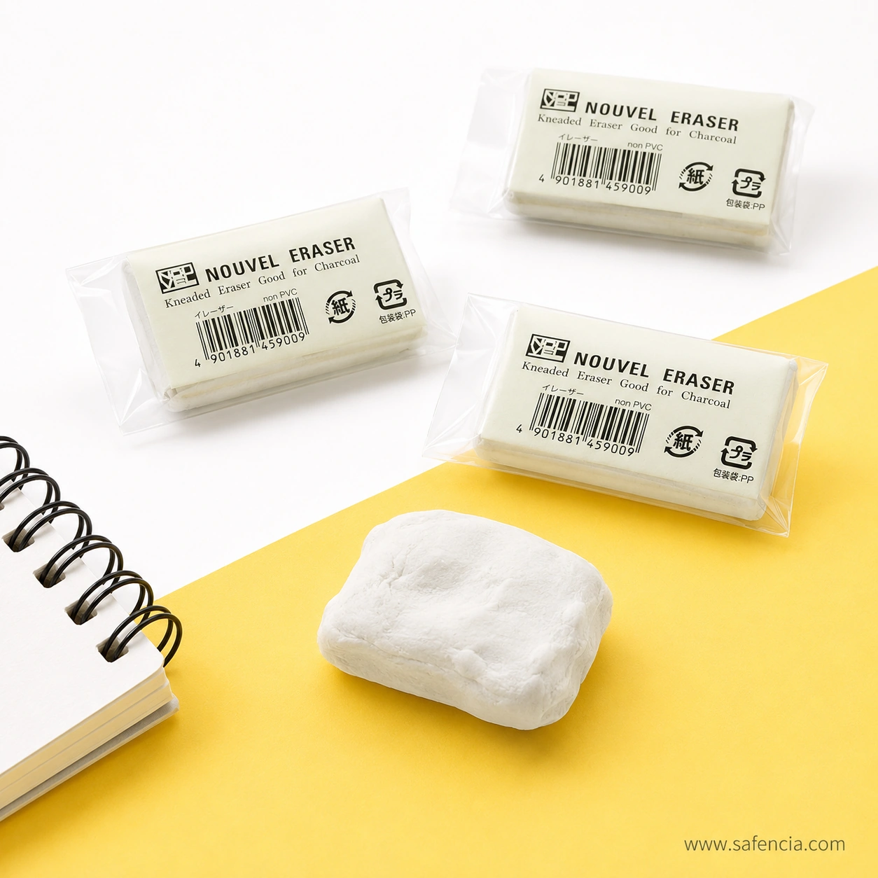 Three sealed Sakura Nouvel kneaded erasers with a worked white block in front, showing the printed barcode, Japanese labelling and recycling marks on each wrapper