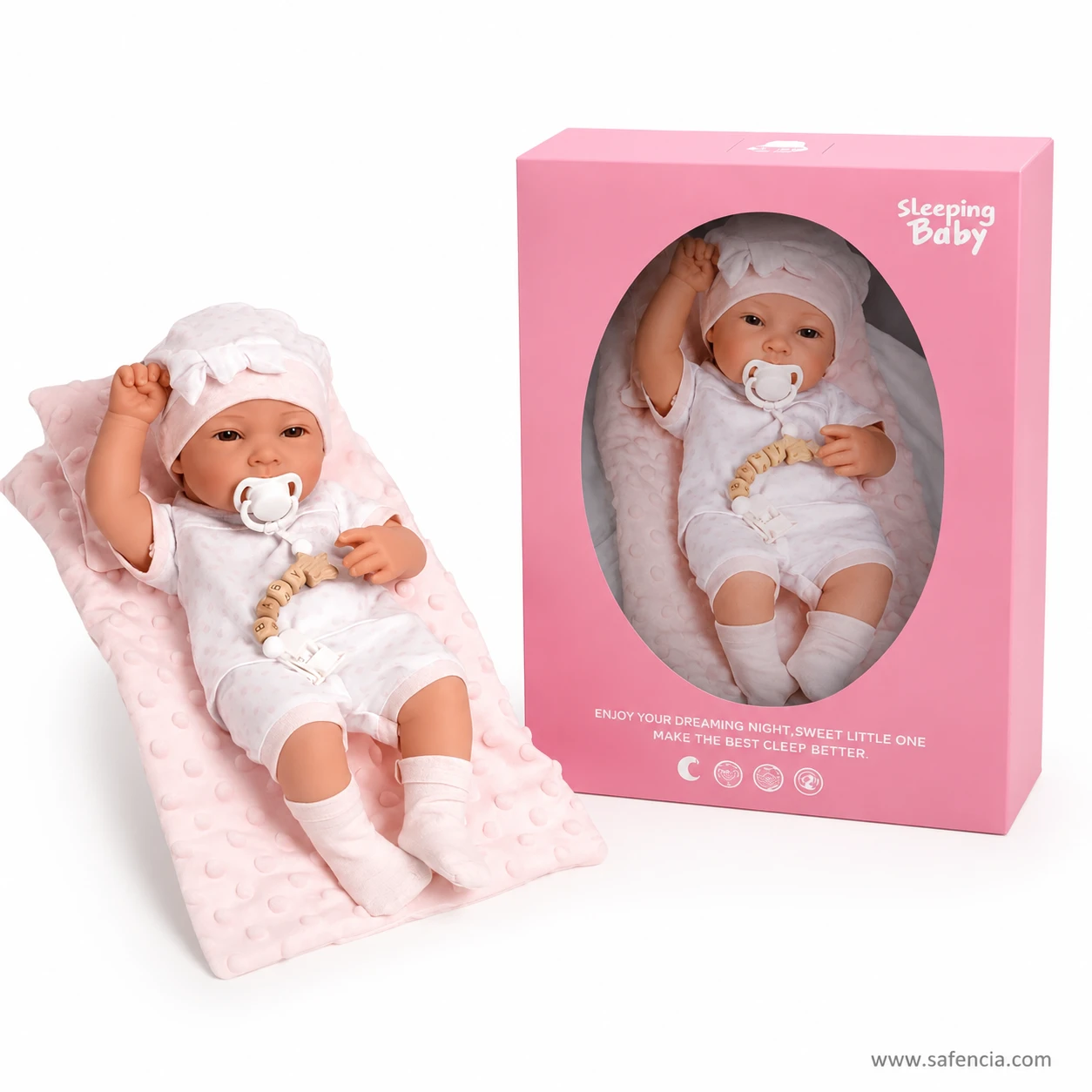Sleeping Baby doll on her blanket lying beside the closed pink presentation box