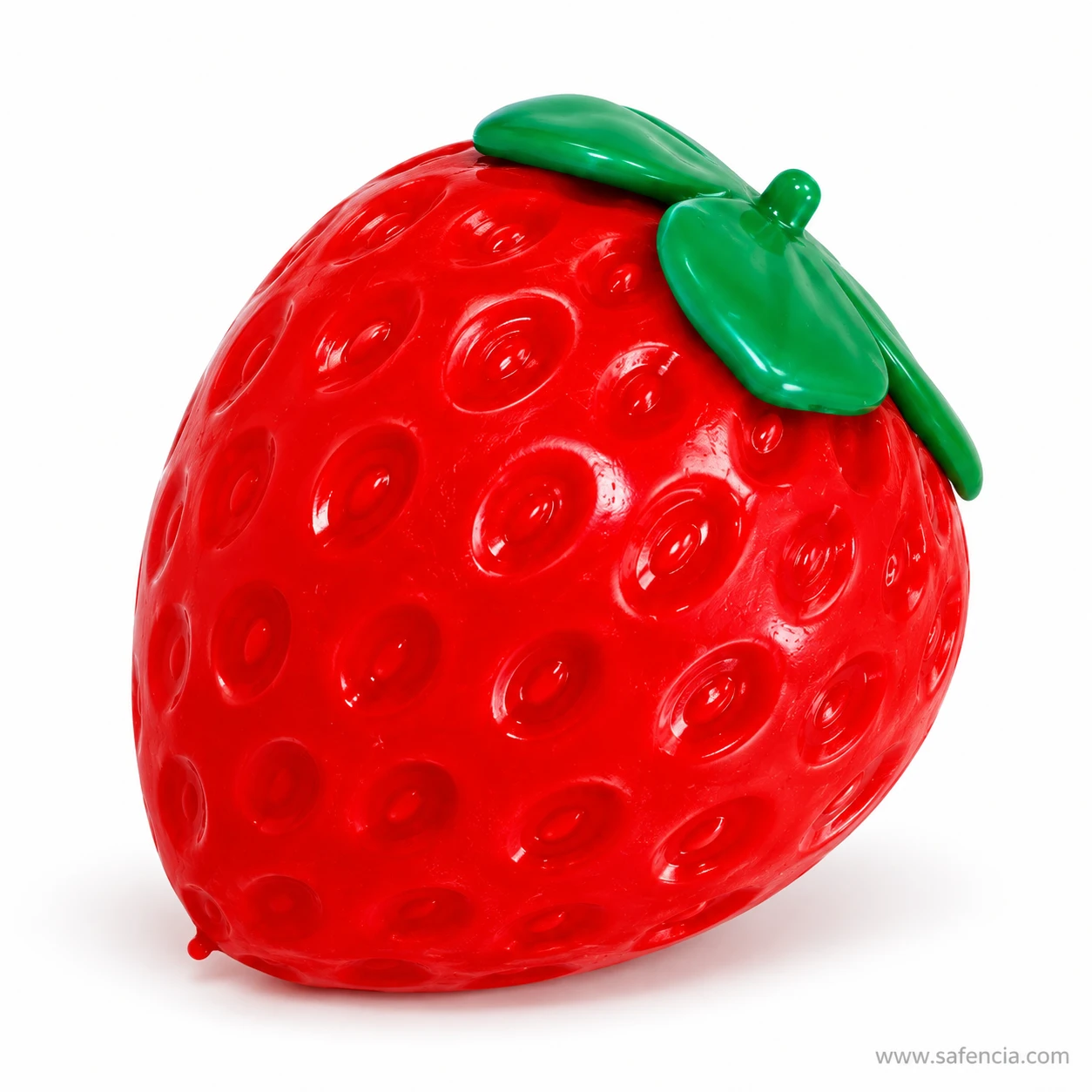 Angled view of the strawberry squishy with its green leaf cap tilted to one side