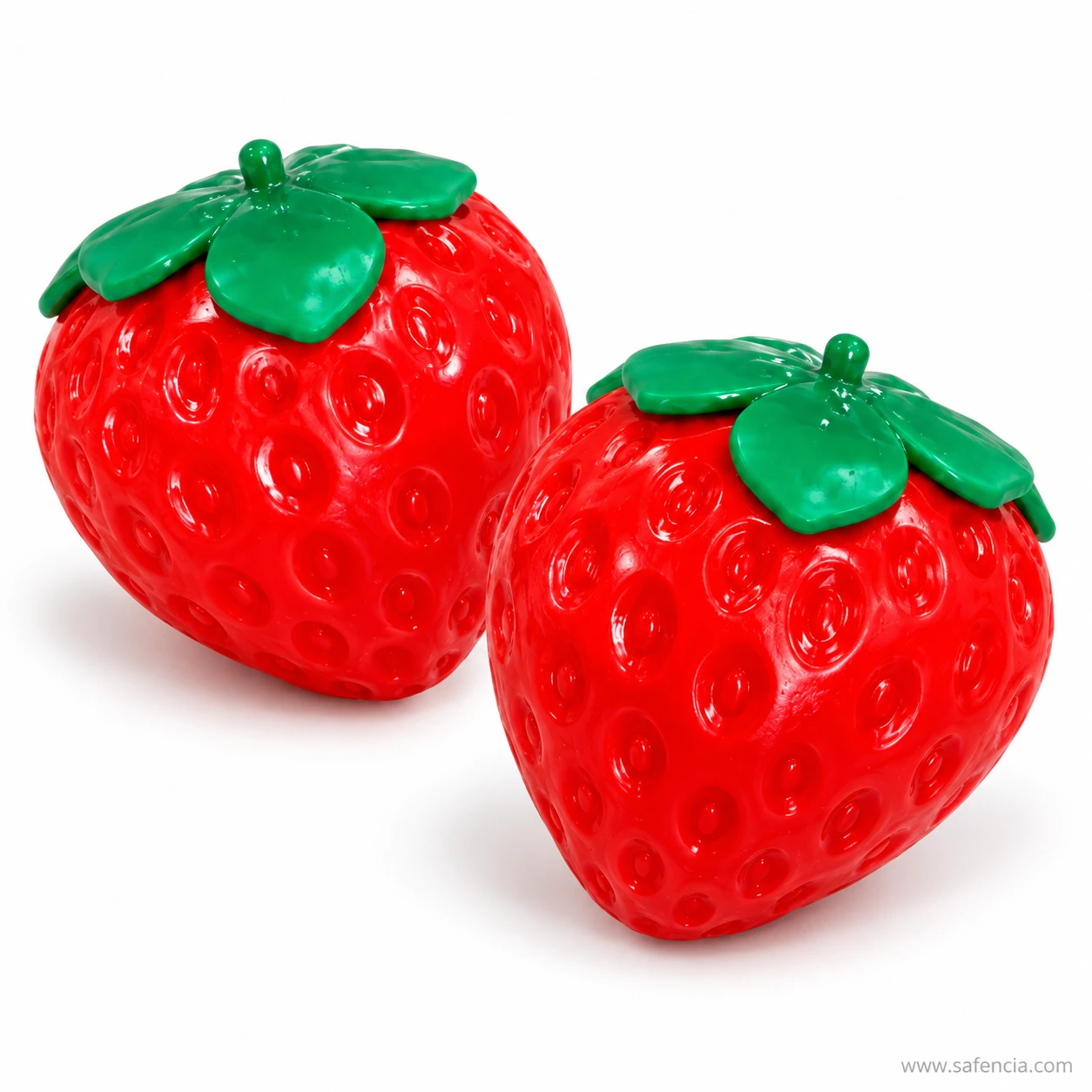 Two glossy strawberry squishies side by side with green leaf caps on a white background