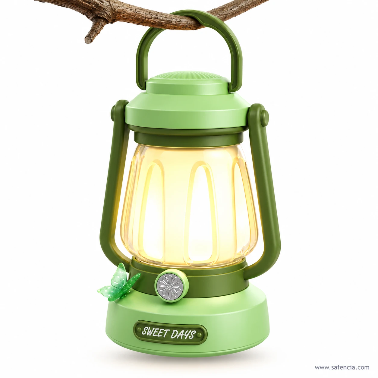 Green Sweet Days LED lantern hanging by its top handle from a tree branch, its shade glowing warm yellow