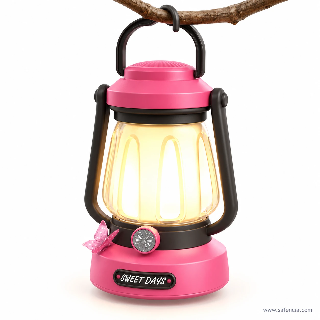 Pink Sweet Days LED lantern with a black handle hanging from a tree branch, its ribbed shade glowing warm yellow