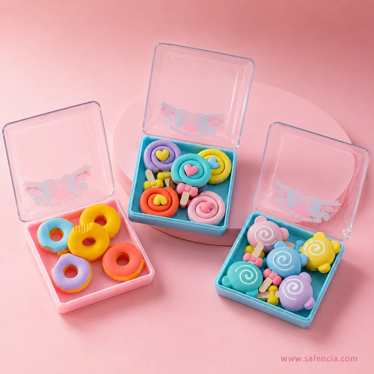 Sweets candy eraser boxes arranged around a round pink podium showing all three themed sets together
