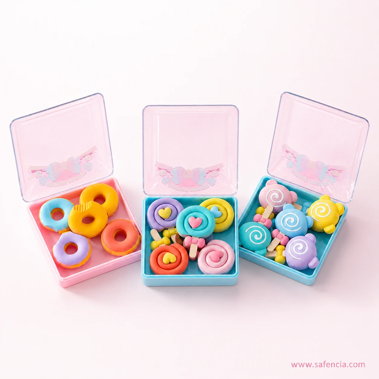 Straight-on view of the sweets candy eraser boxes with hinged lids standing open on a pink background