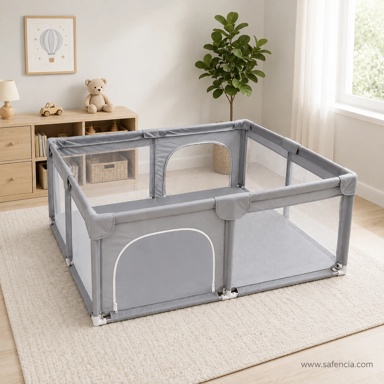 Large grey mesh baby playpen standing on a rug in a nursery with no floor mat inside the pen