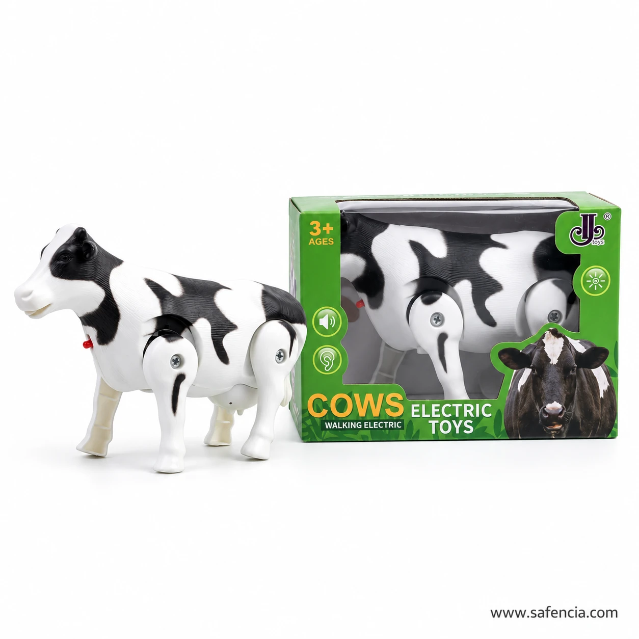 Side view of the black and white walking cow toy beside its green box, with its head, tail and four legs visible