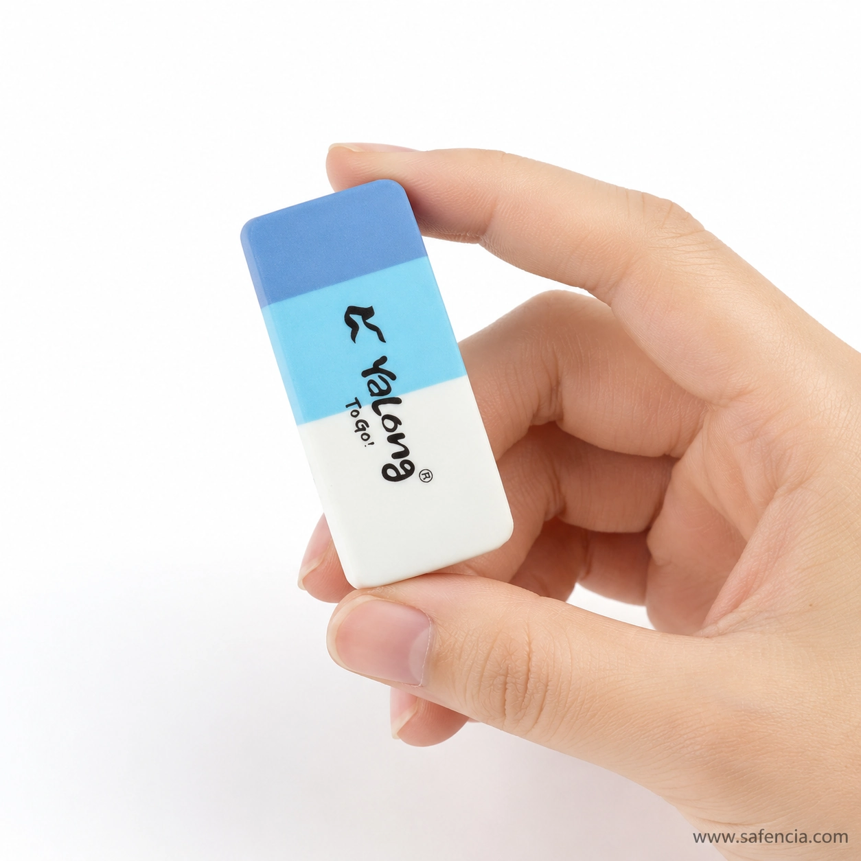 Hand holding the blue Yalong Y221535 eraser between finger and thumb showing its compact size and rounded corners